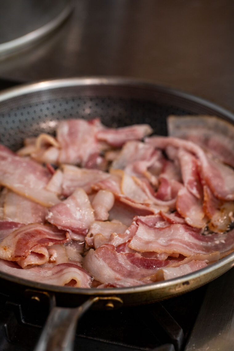 Cooking bacon in a skillet.